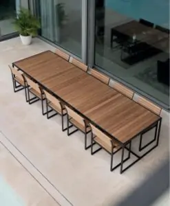 Garden Ease Dining Table — Outdoor dining table with benches on a patio, adjacent to sliding glass doors